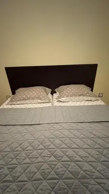 a bed with two pillows on top of it at Cosy apartment 11Mins Center in Plovdiv