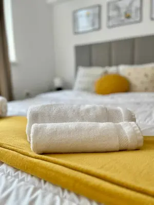 two towels sitting on top of a bed at Central 53 Vitosha View 2BD Apartment in Sofia