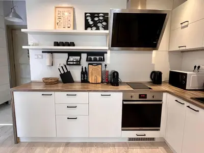 a kitchen with white cabinets and a counter top at Central 53 Vitosha View 2BD Apartment in Sofia