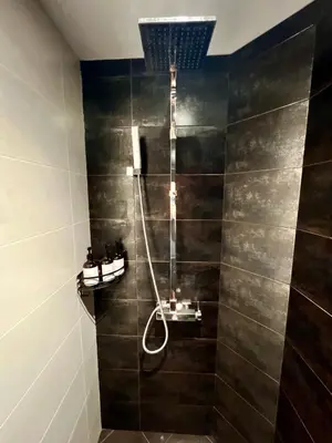 a bathroom with a shower with a sink at Central 53 Vitosha View 2BD Apartment in Sofia