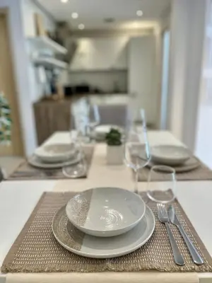 a table topped with plates and silverware on a table at Central 53 Vitosha View 2BD Apartment in Sofia
