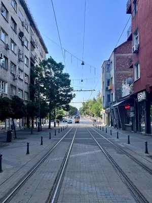 an empty street with train tracks in a city at Central 53 Vitosha View 2BD Apartment in Sofia