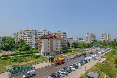 a busy city street with cars and a truck at Brand New Vitosha View Apartment - Free Parking - Metro Access in Sofia