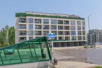 a bus stop in front of a large building at Brand New Vitosha View Apartment - Free Parking - Metro Access in Sofia