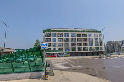 a bus stop in front of a large building at Brand New Vitosha View Apartment - Free Parking - Metro Access in Sofia