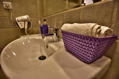 a purple basket sitting on top of a bathroom sink at Villa Dream in Dobrevtsi