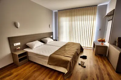a bedroom with a bed and a large window at Villa Dream in Dobrevtsi