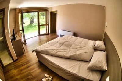 a bedroom with a large bed in a room at Villa Dream in Dobrevtsi