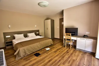 a bedroom with a bed and a desk with a computer at Villa Dream in Dobrevtsi