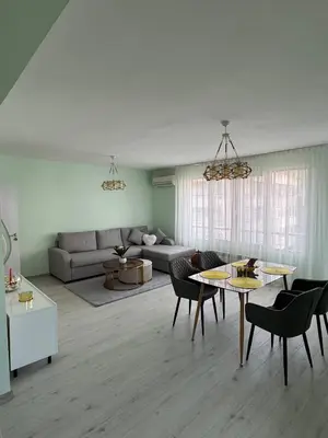 a living room with a couch and a table and chairs at Contemporary Comfort in Lozenets in Sofia