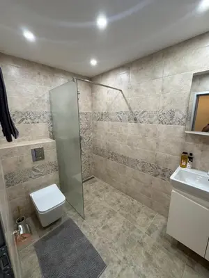 a bathroom with a shower and a toilet and a sink at Contemporary Comfort in Lozenets in Sofia