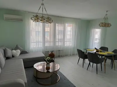 a living room with a couch and a table at Contemporary Comfort in Lozenets in Sofia