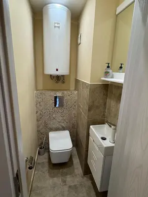 a small bathroom with a toilet and a sink at Contemporary Comfort in Lozenets in Sofia