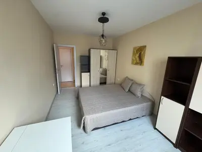 a small bedroom with a bed and a mirror at Contemporary Comfort in Lozenets in Sofia