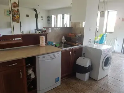 a kitchen with a sink and a washing machine at Стаи за гости ЖиВел in Oreshak