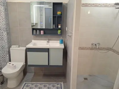 a bathroom with a sink and a toilet and a shower at MOD - Opera Plovdiv in Plovdiv
