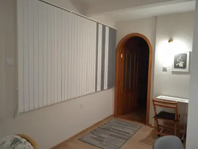a room with a door and a chair and a table at MOD - Opera Plovdiv in Plovdiv