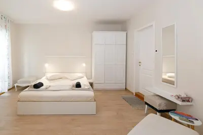 a white bedroom with a bed in a room at MOD - Opera Plovdiv in Plovdiv