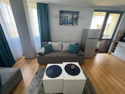 a living room with a couch and a table at Apartment 2-6 Royal Park in Bansko