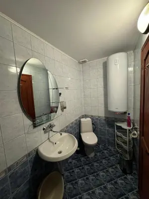 a bathroom with a sink and a toilet and a mirror at Guest House in Rhodope Mountains in Rudozem