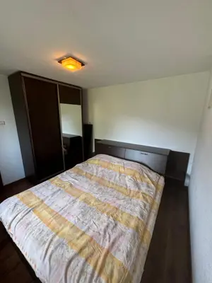 a bedroom with a bed with a blanket on it at Guest House in Rhodope Mountains in Rudozem