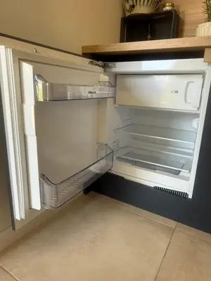 an empty refrigerator with its door open in a kitchen at Villa Green House in Tscherweni Breg