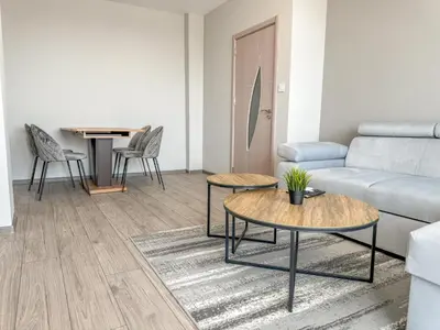 a living room with a couch and tables at 1BR Apartment with Panoramic View Balcony and Designated Parking Space in Plovdiv