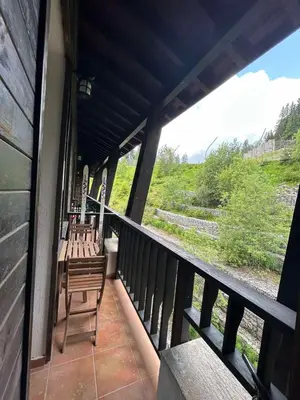 a balcony of a house with a table and chairs at Aпартамент за гости SKI DREAM Grand Monastery-Пампорово in Pamporovo