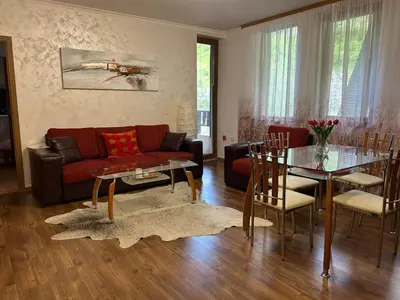a living room with a couch and a table at Aпартамент за гости SKI DREAM Grand Monastery-Пампорово in Pamporovo
