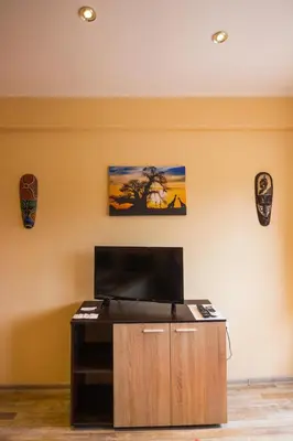a room with a tv on a wall at SimplyComfy in Plovdiv
