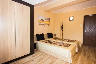 a bedroom with a bed and a closet at SimplyComfy in Plovdiv