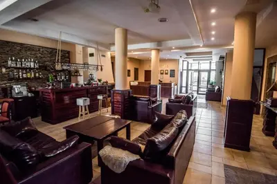 a lobby with couches and a bar in a building at Orbilux - Cozy Studio in Bansko by Flat Mаnager in Bansko