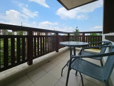 a patio with a table and chairs on a balcony at Orbilux - Cozy Studio in Bansko by Flat Mаnager in Bansko