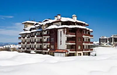 a building covered in snow in the snow at Orbilux - Cozy Studio in Bansko by Flat Mаnager in Bansko
