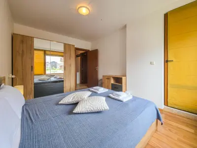 a bedroom with a blue bed with two pillows on it at Cozy 1BD Flat in Pirin Sense by Flat Manager in Bansko