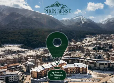 a green balloon in the middle of a city with mountains at Cozy 1BD Flat in Pirin Sense by Flat Manager in Bansko