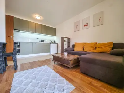 a living room with a couch and a table at Cozy 1BD Flat in Pirin Sense by Flat Manager in Bansko