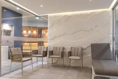 a group of chairs in a room with a wall at Cozy 1BD Flat in Pirin Sense by Flat Manager in Bansko