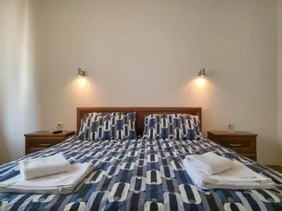 a bedroom with a bed with two towels on it at Charming 1BD Flat at Edelweiss Inn, Bansko by Flat Mаnager in Bansko