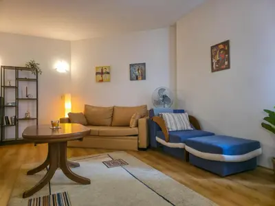 a living room with a couch and a table at Charming 1BD Flat at Edelweiss Inn, Bansko by Flat Mаnager in Bansko