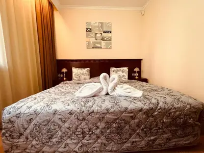 a bedroom with a bed with towels on it at Gondola luxury apartment 2 in Bansko