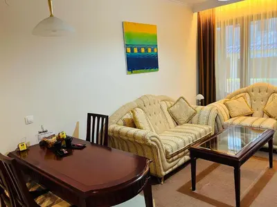 a living room with two couches and a table at Gondola luxury apartment 2 in Bansko