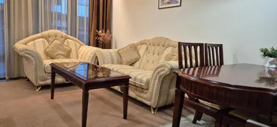 a living room with a couch and a table at Gondola luxury apartment 2 in Bansko