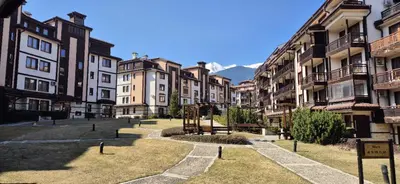 a group of buildings in a city with mountains in the background at Gondola luxury apartment 1 in Bansko