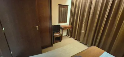 a hotel room with a bed and a television at Gondola luxury apartment 1 in Bansko
