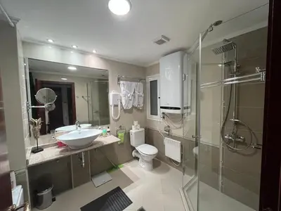 a bathroom with a sink and a toilet and a shower at Gondola luxury apartment 1 in Bansko