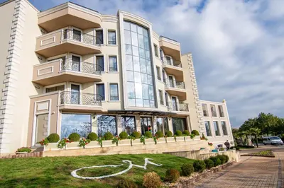 a building with a white horse in front of it at Mantar Spa Hotel in Marikostinovo