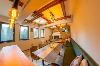 a dining room with a long table and chairs at Villa Veranda in Smolyan