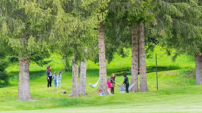 a group of people playing in a park with trees at Villa Veranda in Smolyan