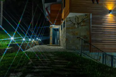 a house with a staircase leading to a door at night at Villa Veranda in Smolyan